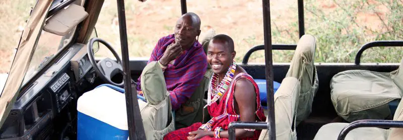 Maasai guide and tracker in safari jeep